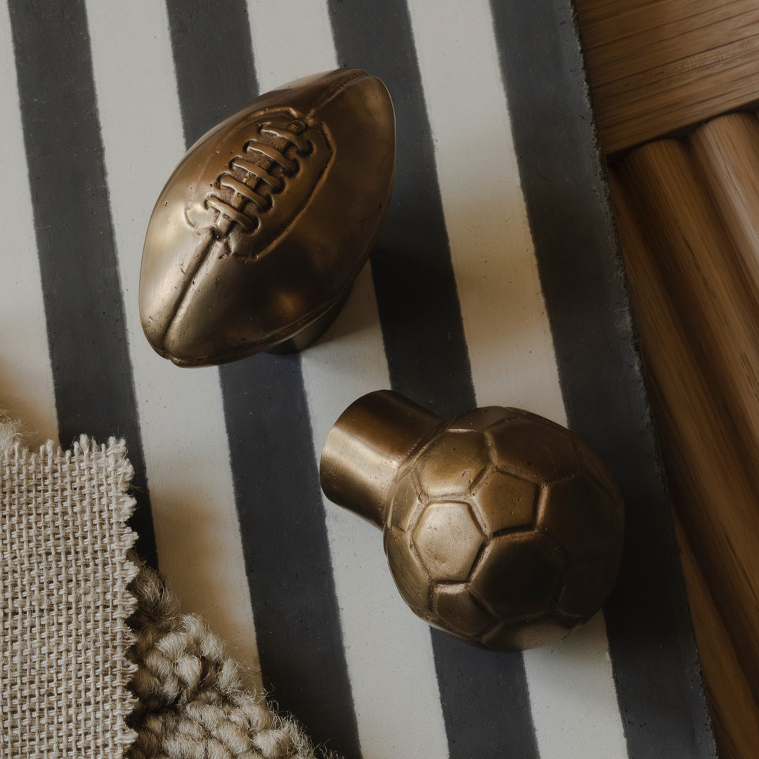Photography by Joey Kendal Brown | Whimsical American Football Cabinet Knob and Football Cabinet Knob shown in burnished bronze (BR). 