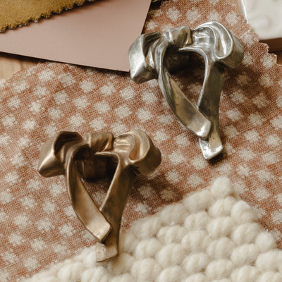 Photography by Joey Kendal Brown | Whimsical Bow Cabinet Knobs shown in burnished bronze (BR) and burnished white bronze (WB). 

